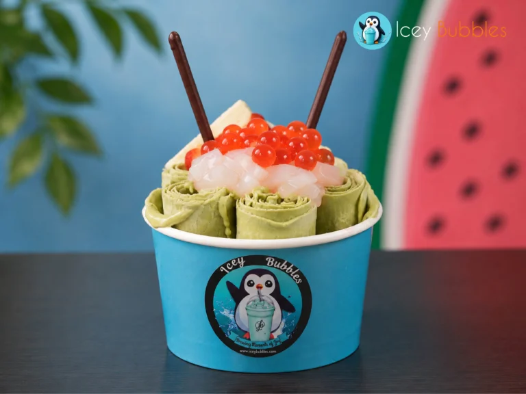 Matcha rolled ice cream topped with popping boba, jelly, and chocolate sticks at Icey Bubbles in Ajax